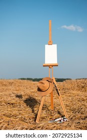 Painter setup ready to paint some picture on empty white canvas on the wooden easel outdoors, concept of art