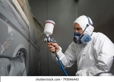 Painter Spray Gun In The Hands Of A Painter.