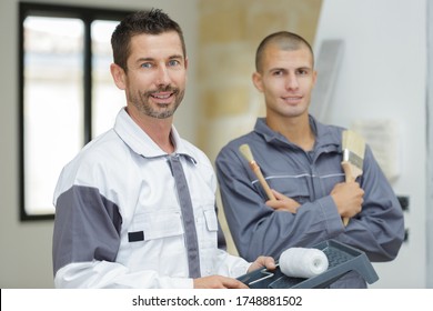 A Painter Team Smiling At Camera