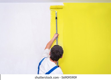 Painter Use Paint Roller On White Wall