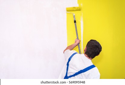 Painter Use Paint Roller On White Wall