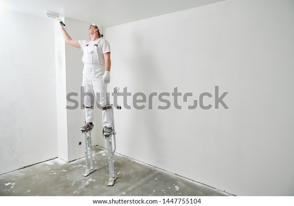 Painter Worker On Stilts Roller Painting Stock Photo Edit Now