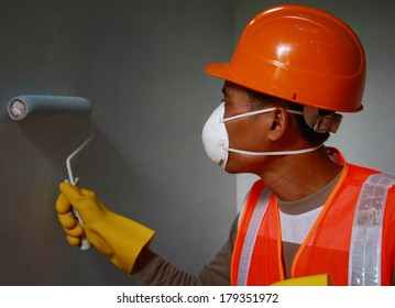 Painter Worker Wearing Safety Mask Or Safety Work On Job, Painting Of Building House Or Apartment Wall With Roll