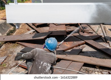 The Painter Is Working To Fireproof Paint On Steel Structure With Spray Gun, At Industrial Factory.