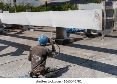 The Painter Is Working To Fireproof Paint On Steel Structure With Spray Gun, At Industrial Factory.