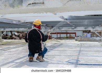 The Painter Is Working To Fireproof Paint On Steel Structure With Spray Gun, At Industrial Factory.