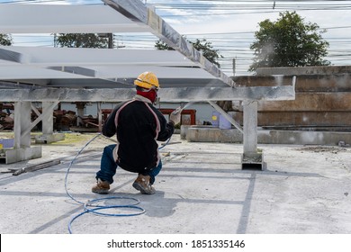 The Painter Is Working To Fireproof Paint On Steel Structure With Spray Gun, At Industrial Factory.