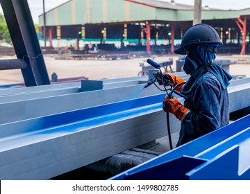 The Painter Is Working To Painting The Steel Structure With Spray Gun At Industrial Factory