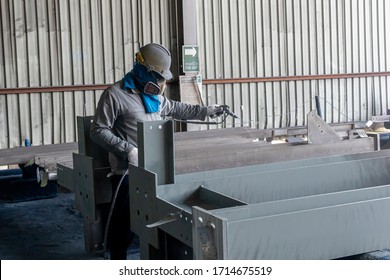 The Painter Is Working To Painting The Steel Structure With Spray Gun At Industrial Factory.