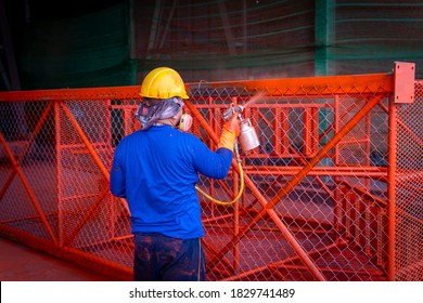 The Painter Is Working To Painting The Steel Structure With Spray Gun, At Industrial Factory.