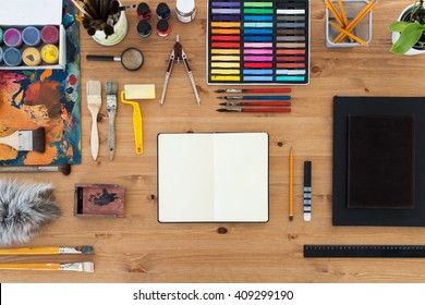 Painter Workplace Top View. Wooden Table Of An Artist With Art Tools For Drawing.