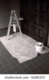 A Painter's Equipment: Stepladder, Bucket And Drop Cloth