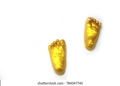 Painting A Gold Color On Baby Foot Prints Which Made From Gypsum