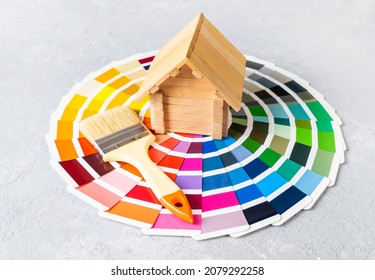 Painting the house or house renovation concept with little wooden house and brush on the color palette catalog. - Shutterstock ID 2079292258