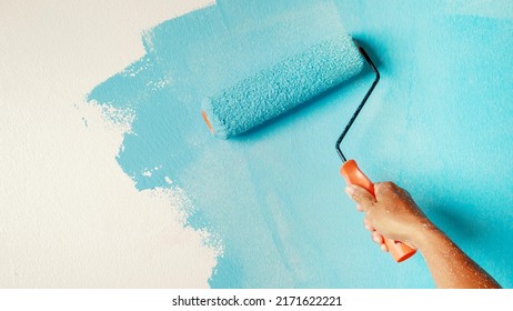  painting interior wall with paint roller  - Shutterstock ID 2171622221