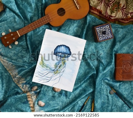 Painting of jellyfish on blue turquoise silk background summer hobby