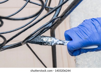 Painting The Metal Chairs With A Brush