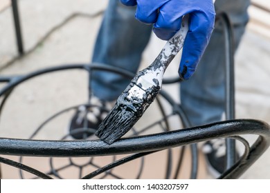 Painting The Metal Chairs With A Brush