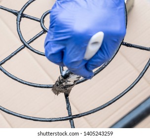 Painting The Metal Chairs With A Brush