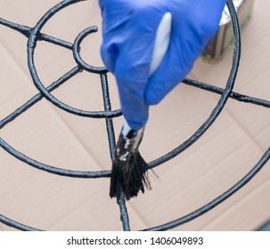 Painting The Metal Chairs With A Brush