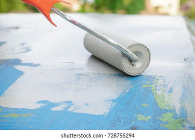 Painting A Metal Surface With Paint Primer Using A Roller. Close Up