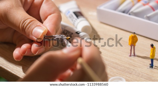 painting miniature\
people  and painting\
tools