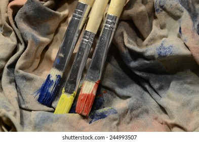 Painting A Picture Of Saturated Colors With Acrylic Paints Using Brushes Of Different Sizes