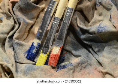 Painting A Picture Of Saturated Colors With Acrylic Paints Using Brushes Of Different Sizes