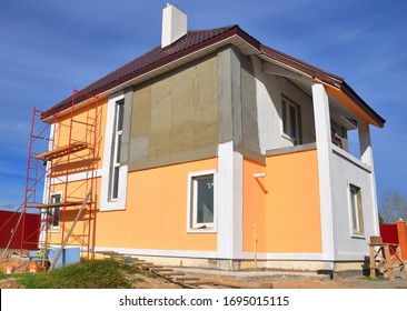 Painting Renovation A Modern House With Stucco House Finish, Stucco Siding And Metal Roof Using Scaffolding.