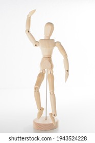 Painting Sketch Wooden Man Model Artist Movable Limbs Doll Wood Carving Man Wooden Toy Art Draw Action Figure Mannequin Kids Toy Puppet With An Arm Up, On A Reflective Mirrored White Floor And White