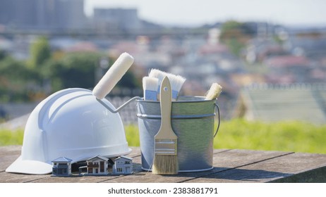Painting tools, model house and hard hat. Image of painting industry, renovation and DIY.