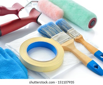 Painting Tools On White Background. Paint Rollers, Brushes, Drop Cloth, Masking Tape And Gloves.