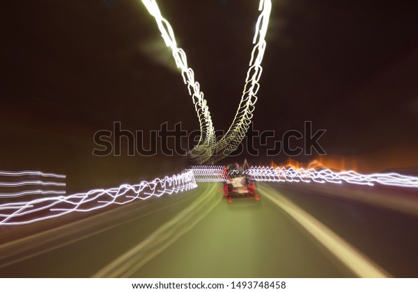 Painting with tunnel lighting system - abstract image of\
a car in road 