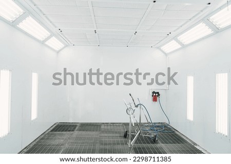 Painting of vehicles in a room with a filter and good light. Spray paint cabinet in a car repair station. Auto service concept.
