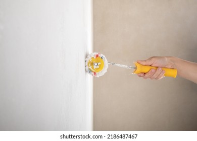 Painting The Wall With Latex Paint Roller.