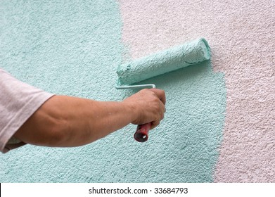 Painting Wall With A Roll In Green Outdoor