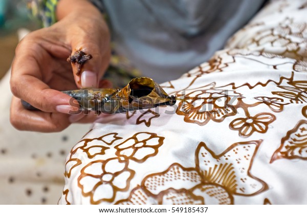 Painting watercolor on the fabric to make Batik. Batik-making is part of Indonesian culture