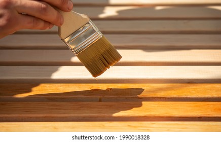 Painting wooden furniture with varnish. a man hides a tree with varnish. - Powered by Shutterstock