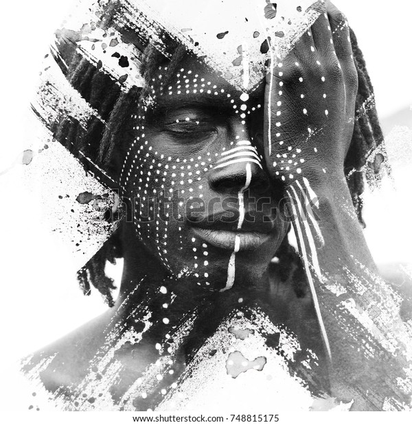 Paintography. African man with traditional style face paint dissolving behind smoky and ink texture