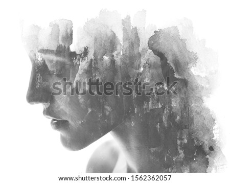 Paintography. Double exposure. Profile portrait photograph blends with hand made black ink painting on white background
