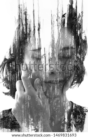 Paintography. Double exposure. Young girl with short hair disappears behind hand made ink painting with lines dissolving into her face. Black and white