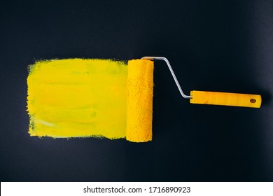 Paintroller for repairs isolated on black background in yellow paints