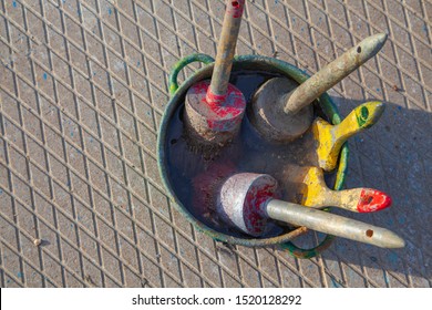 Paints and construction brushes, used paint brushes in a jar with solvent on a concrete slab - Powered by Shutterstock