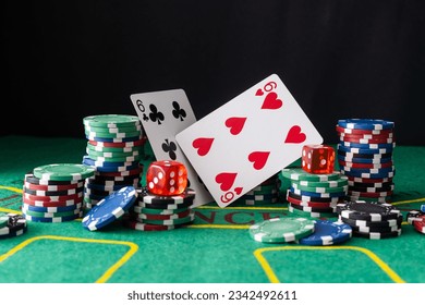 A pair of aces and stack of chips on casino green table. - Powered by Shutterstock