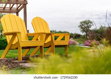 A pair of Adirondack chairs in a garden