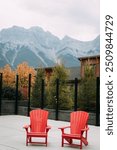 Pair of adirondak chairs in front of picturesque Canadian Rockies