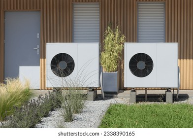 A pair of air source heat pumps, an eco-friendly home heating solution, installed at a contemporary residential property.