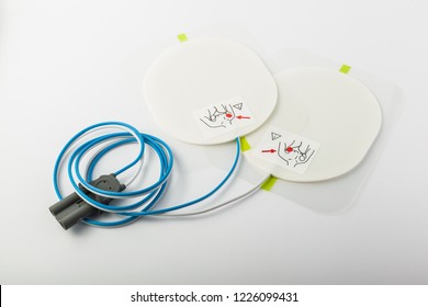 a pair of automatic defibrillator patches on a white table