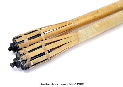 a pair of bamboo torches isolated on a white background
