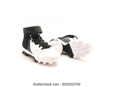A pair of baseball cleats, baseball shoes for kids isolated on white background.